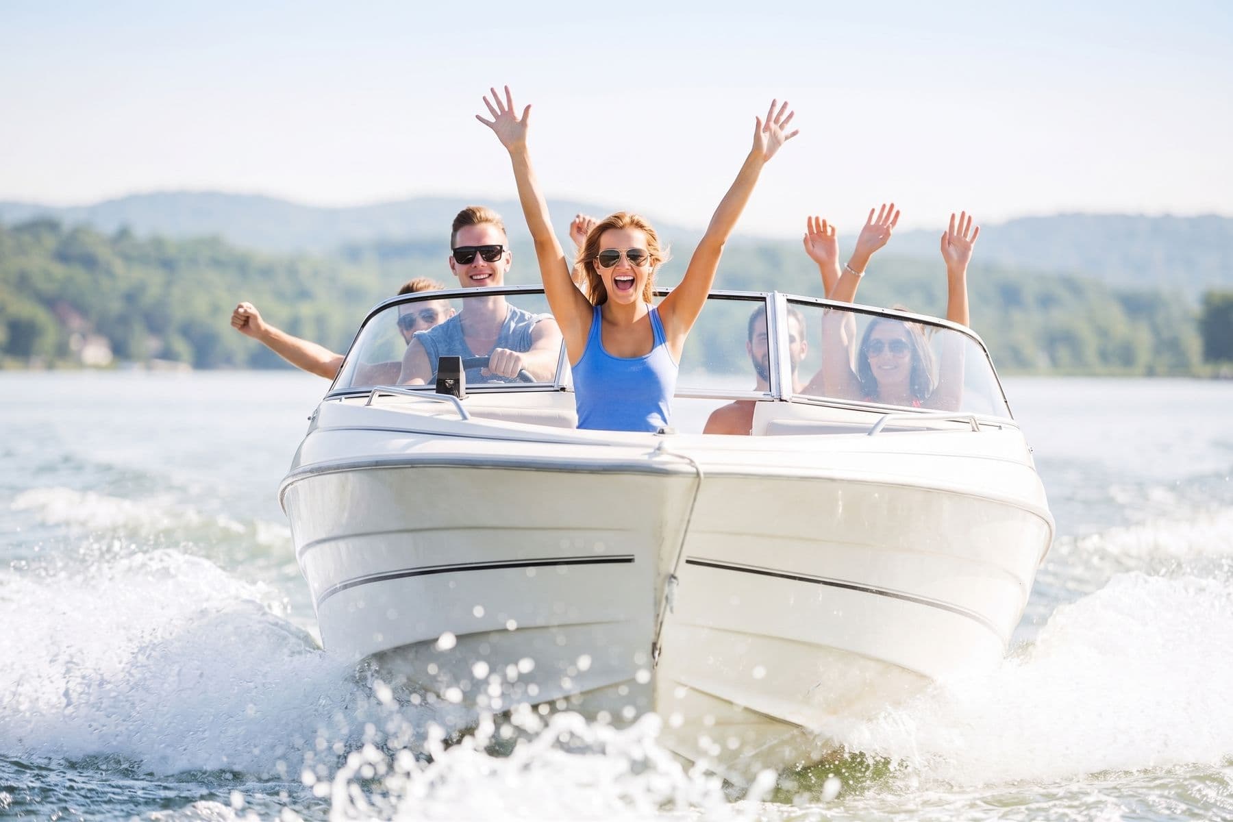 Friends celebrating aboard a speedboat on a summer afternoon